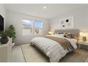 Cozy bedroom featuring neutral walls, carpet flooring, and a window for natural light at 8705 Winter Breeze Way, Sarasota, FL 34241