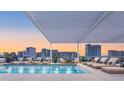 Relaxing rooftop pool with lounge chairs and city views, perfect for unwinding and enjoying the scenery at 1305 4Th St # 302F, Sarasota, FL 34236