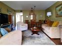 Inviting living room with stylish furnishings, patterned rug, and view to a dining area at 137 Pineneedle Dr # 137, Bradenton, FL 34210
