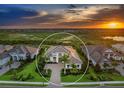 Areal view showing the elegant two-story home featuring a beautiful stone driveway, manicured landscaping at 16917 Clearlake Ave, Lakewood Ranch, FL 34202