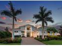 Elegant two-story home featuring a beautiful stone driveway, manicured landscaping, and a welcoming front entrance at 16917 Clearlake Ave, Lakewood Ranch, FL 34202