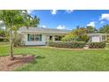 Charming home boasting a lush green lawn and beautiful, mature landscaping at 2088 Grove St, Sarasota, FL 34239