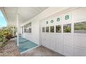 Attached white garage door displaying house numbers with adjacent covered walkway at 2088 Grove St, Sarasota, FL 34239