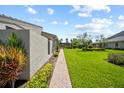 Well-maintained backyard featuring green lawn and landscaping at 2181 Harbourside Dr # 1403, Longboat Key, FL 34228