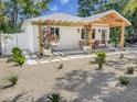 Single-story home with modern landscape design, front porch, and a hanging chair at 2189 Hillview St, Sarasota, FL 34239