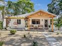 Inviting single-story home with light exterior and an outdoor seating area at 2189 Hillview St, Sarasota, FL 34239