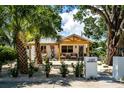 Beautiful white home with desert landscaping, palm trees, and a cozy egg chair at 2189 Hillview St, Sarasota, FL 34239
