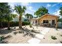 Attractive home with desert landscaping, a cozy hanging chair, and mature palm trees at 2189 Hillview St, Sarasota, FL 34239