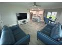 Open concept living room featuring stylish gray flooring that flows into a dining and kitchen space at 22214 Felton Ave, Port Charlotte, FL 33952