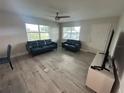 The bright living room has neutral walls, light colored floors and lots of natural light at 22214 Felton Ave, Port Charlotte, FL 33952