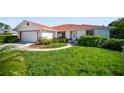 Charming single-story home with lush lawn and well-manicured landscaping at 22378 Peachland Blvd, Port Charlotte, FL 33954