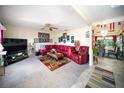 Cozy living room featuring comfortable seating and neutral carpeting at 22378 Peachland Blvd, Port Charlotte, FL 33954