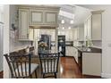 Bright kitchen with custom cabinets, granite countertops, and modern black appliances at 2559 Wood Oak Dr, Sarasota, FL 34232
