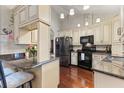 Bright kitchen with custom cabinets, granite countertops, and modern black appliances at 2559 Wood Oak Dr, Sarasota, FL 34232