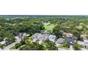 An elevated view of a neutral-colored home with a two-car garage surrounded by lush landscaping at 2590 Floyd St, Sarasota, FL 34239