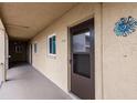 Exterior walkway features neutral colors and leads to unit 410 at 3635 Lake Bayshore Dr # J-410, Bradenton, FL 34205