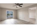 Bright main bedroom with luxury vinyl plank flooring, a ceiling fan and a water view at 3635 Lake Bayshore Dr # J-410, Bradenton, FL 34205