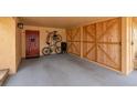 Spacious carport with a painted floor, wooden storage, and convenient bike parking at 3850 Catalina Dr, Bradenton, FL 34210