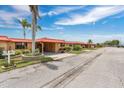 Street view of a quaint neighborhood with well-maintained lawns and matching orange roofs at 3850 Catalina Dr, Bradenton, FL 34210