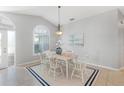 Bright dining room featuring a vaulted ceiling, large window, and stylish chandelier at 5206 19Th W Ave, Bradenton, FL 34209