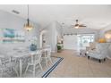 Open-concept dining room with tile floors, stylish chandelier, and sliding barn door at 5206 19Th W Ave, Bradenton, FL 34209