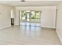 Spacious open-concept living area with light tile flooring and sliding glass doors to the lanai at 544 Mount Vernon Dr, Venice, FL 34293
