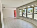 Bright living room with light tile flooring and large bay window overlooking the front yard at 544 Mount Vernon Dr, Venice, FL 34293