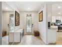 Bright foyer featuring tile flooring, decorative door, and storage at 5916 Wake Forest Run # 101, Bradenton, FL 34211
