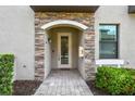 Inviting front entrance with stone accents and a glass-paneled door and tile walkway at 5916 Wake Forest Run # 101, Bradenton, FL 34211