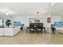 Spacious living room with tile flooring, a ceiling fan, and an open dining area at 5916 Wake Forest Run # 101, Bradenton, FL 34211