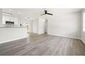 Open-concept living area with updated light gray floors seamlessly flowing into the kitchen and dining spaces at 609 Carmel Rd, Venice, FL 34293