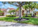 Beautiful home with a well-maintained lawn, mature trees, and tropical landscaping at 6312 41St E Ct, Sarasota, FL 34243