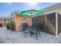 A shaded outdoor dining area with a grill is perfect for entertaining guests at 6806 Palm Dr, Holmes Beach, FL 34217