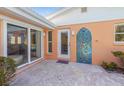 Charming patio includes an outdoor shower adorned with colorful mosaic tiles at 6806 Palm Dr, Holmes Beach, FL 34217