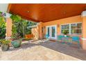 Covered patio with a tile floor and a seating area offers a serene outdoor space at 6806 Palm Dr, Holmes Beach, FL 34217