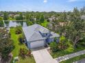 Scenic aerial view of home on lush lot with water view and mature trees at 7026 43Rd E Ave, Palmetto, FL 34221