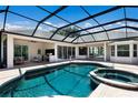 Inviting screened-in pool and hot tub area with ample patio space for outdoor entertaining at 7211 Marston Ct, University Park, FL 34201