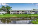Back exterior of a condo overlooking a pond, with a screened lanai circled in red at 7301 W. Country Club N Dr # 108, Sarasota, FL 34243