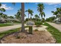 Exterior view of community sign for Palm Aire Golf Side, showing trees and landscaping at 7301 W. Country Club N Dr # 108, Sarasota, FL 34243