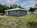 Exterior of a single-Gathering home with a metal roof and well-maintained lawn at 811 24Th Street E Ct, Bradenton, FL 34208