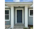 Close-up of the front door framed by white columns and a covered entryway at 811 24Th Street E Ct, Bradenton, FL 34208