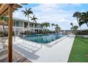 Community pool surrounded by lush landscaping and comfortable lounge chairs at 999 Inlet Cir # 103, Venice, FL 34285