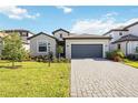 Charming single-story home with a paved driveway, a two-car garage, and well-kept landscaping at 15115 Oxford Grey Dr, Bradenton, FL 34211
