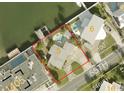 Aerial view shows a home with a pool and waterfront access at 205 55Th Ave, St Pete Beach, FL 33706