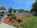 The house exterior is well-landscaped with lush greenery and wood mulch at 2606 29Th Ave W # 12, Bradenton, FL 34205