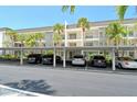 Low-rise condos showcase covered parking, complemented by swaying palm trees, creating a welcoming coastal ambiance at 4380 Exeter Dr # 204, Longboat Key, FL 34228