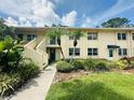 Charming condo building with well-maintained landscaping and inviting entrance at 4805 Rilma Ave # 106, Sarasota, FL 34234