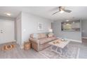 Cozy living room featuring neutral walls, a ceiling fan, and a view into the kitchen and dining area at 522 Pine Ave # 8B, Anna Maria, FL 34216
