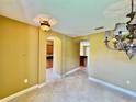 Foyer with tile flooring, decorative lighting, and arched doorways into kitchen and living areas at 5620 Whitehead St, Bradenton, FL 34203