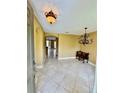 Inviting foyer with tile flooring, decorative lighting, and archway leading to other rooms at 5620 Whitehead St, Bradenton, FL 34203